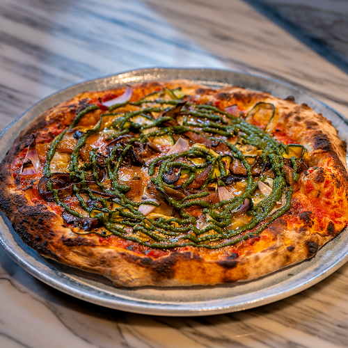 A garden-fresh delight with zucchinis, eggplant, and bell peppers atop a rich combination of tomato & pesto sauce.