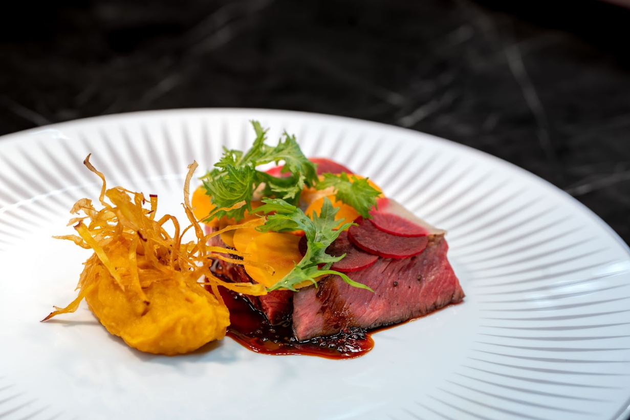 A classic M6 Australian Wagyu Rib-eye steak with a sweet potato miso mousseline with a chianti reduction.