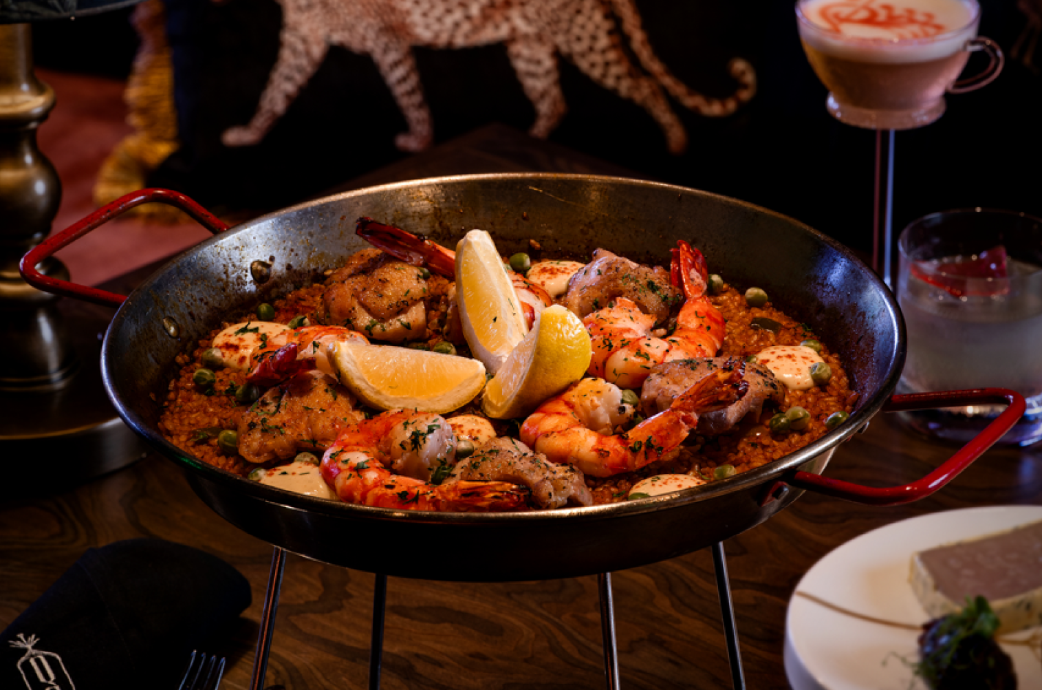 The flavorful Paella Valenciana is perfect for sharing around the table with juicy shrimps and chicken mixed with an aromatic sofrito and saffron.