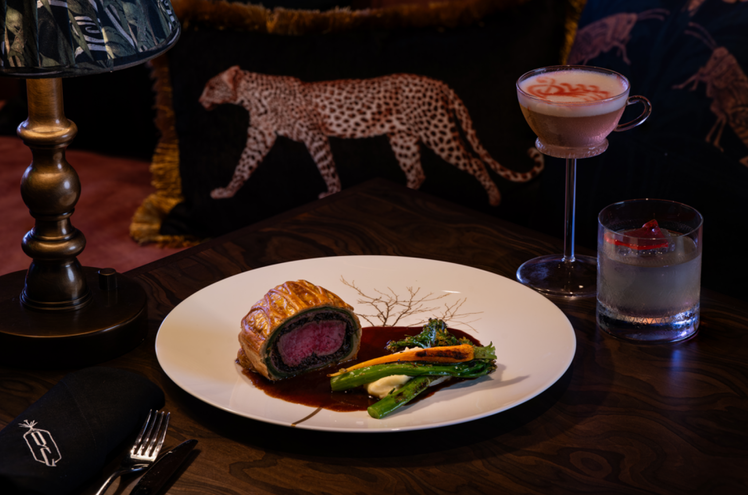 A tender, succulent Beef Wellington for sharing served with a delicate portion of mash, broccolini, and baby carrots for a sumptuous meal.