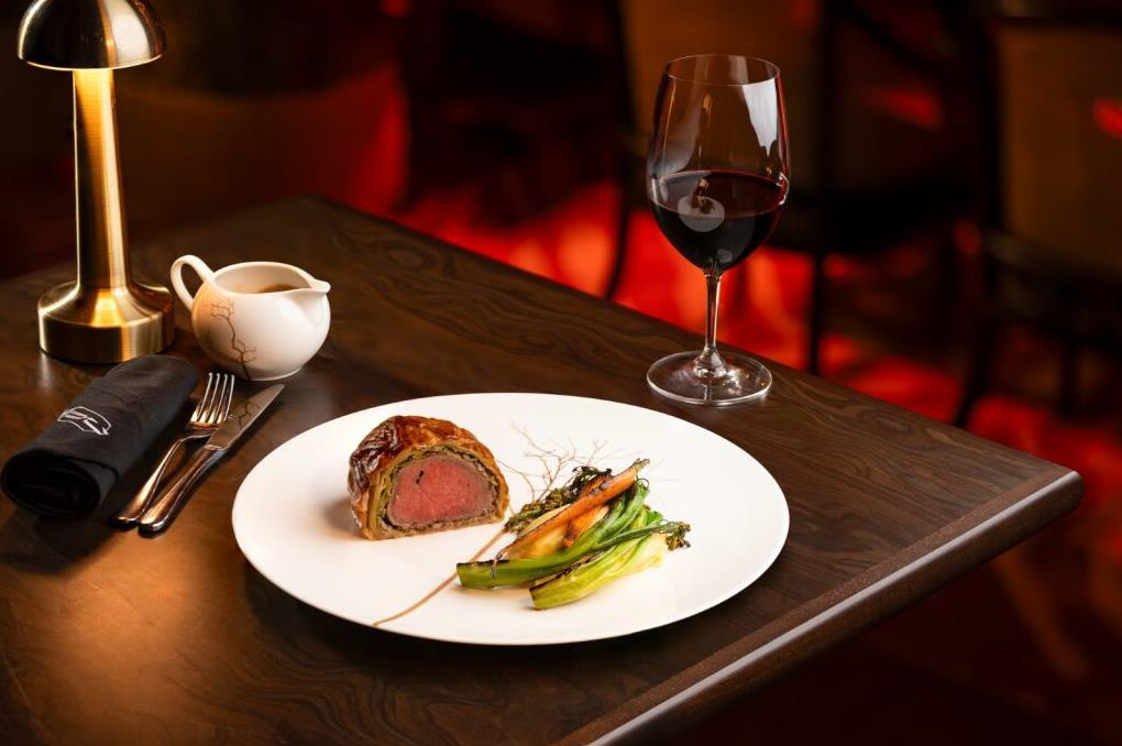 Quezon Club’s Beef Wellington accompanied with a tender mash, broccolini and baby carrots perfect for sharing